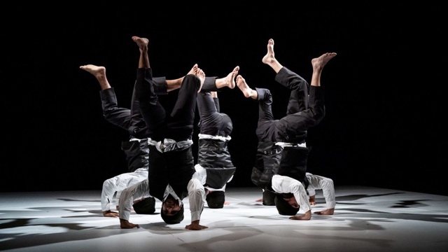 5 b-boys in headstands form a circle