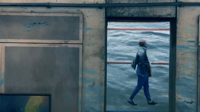 through an open window, we see a woman in a winter jacket appearing to walk on water