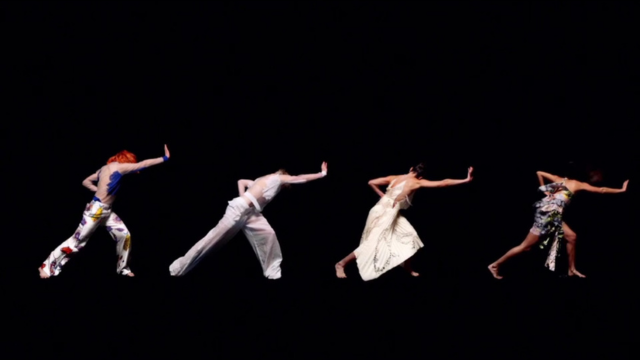on a jet black background, four dancers in varied costumes take wide stances and push their right palms forward