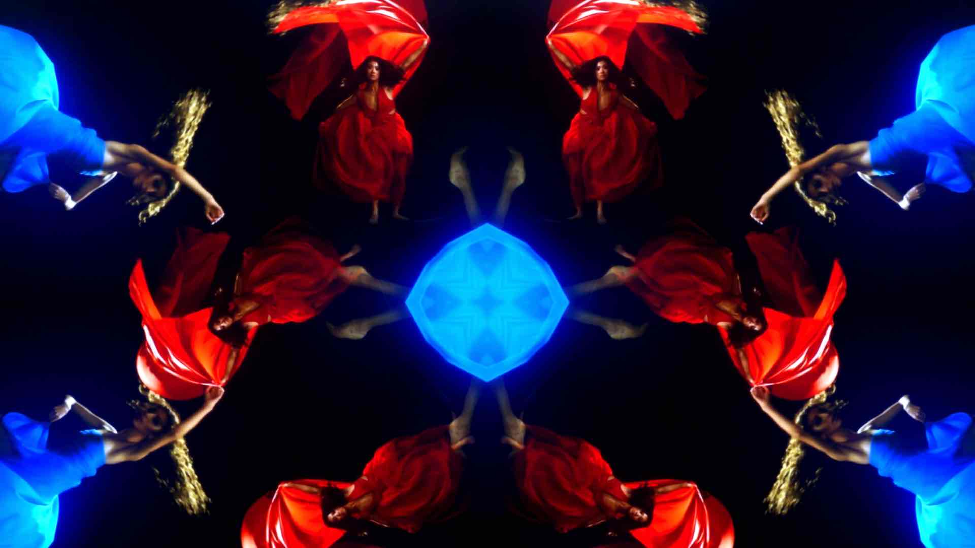 a kaleidoscopic image of two female dancers in bright red and blue dresses